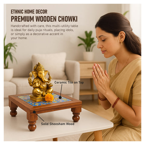 A woman performing a puja ritual with a golden idols of Ganesha on a mini wooden chowki with a colorful ceramic tile on top, placed on a white surface.