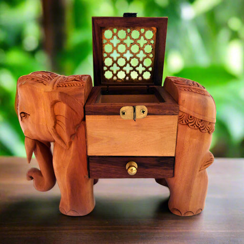 A wooden elephant-shaped incense cone holder with a lid and a small opening on the side.